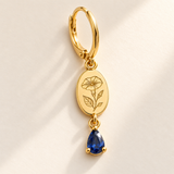 Custom Birth Flower & Birthstone Drop Earrings macro detail photo - complete gold morning glory engraved oval medallion, hinged hoop and September blue pear gemstone Anthology Jewelry