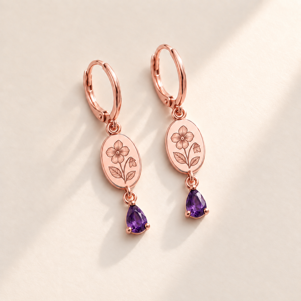 Custom Birth Flower & Birthstone Drop Earrings February rose gold hero photo - violet engraved medallions with purple pear stones Anthology Jewelry