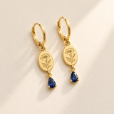 Custom Birth Flower & Birthstone Drop Earrings hero photo - gold morning glory and sapphire earrings Anthology Jewelry