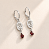 Custom Birth Flower & Birthstone Drop Earrings january silver hero photo - engraved carnation flower with ruffled petals, right bud, narrow leaves with dark garnet red pear stones Anthology Jewelry