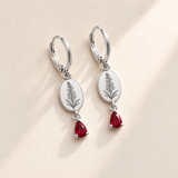 Custom Birth Flower & Birthstone Drop Earrings july silver hero photo - engraved tall larkspur stalk with clustered small flowers, buds and narrow leaves with ruby red pear stones Anthology Jewelry