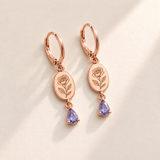 Custom Birth Flower & Birthstone Drop Earrings june rose gold hero photo - engraved rose with layered petals and three leaves with pale lavender violet pear stones Anthology Jewelry