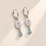 Custom Birth Flower & Birthstone Drop Earrings march silver hero photo - engraved daffodil flower with trumpet pointing right and two long leaves with pale aquamarine blue pear stones Anthology Jewelry