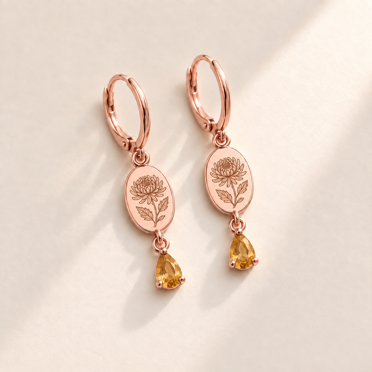 Custom Birth Flower & Birthstone Drop Earrings november rose gold hero photo - engraved chrysanthemum with elongated curled petals and serrated leaves with golden yellow citrine pear stones Anthology Jewelry