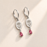 Custom Birth Flower & Birthstone Drop Earrings october silver hero photo - engraved round marigold flower with dense layered petals and serrated leaves with pink tourmaline pear stones Anthology Jewelry