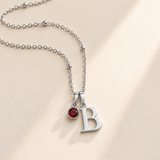 Custom Birthstone Initial Necklace hero silver photo - two separate bails with serif initial B and round birthstone Anthology Jewelry
