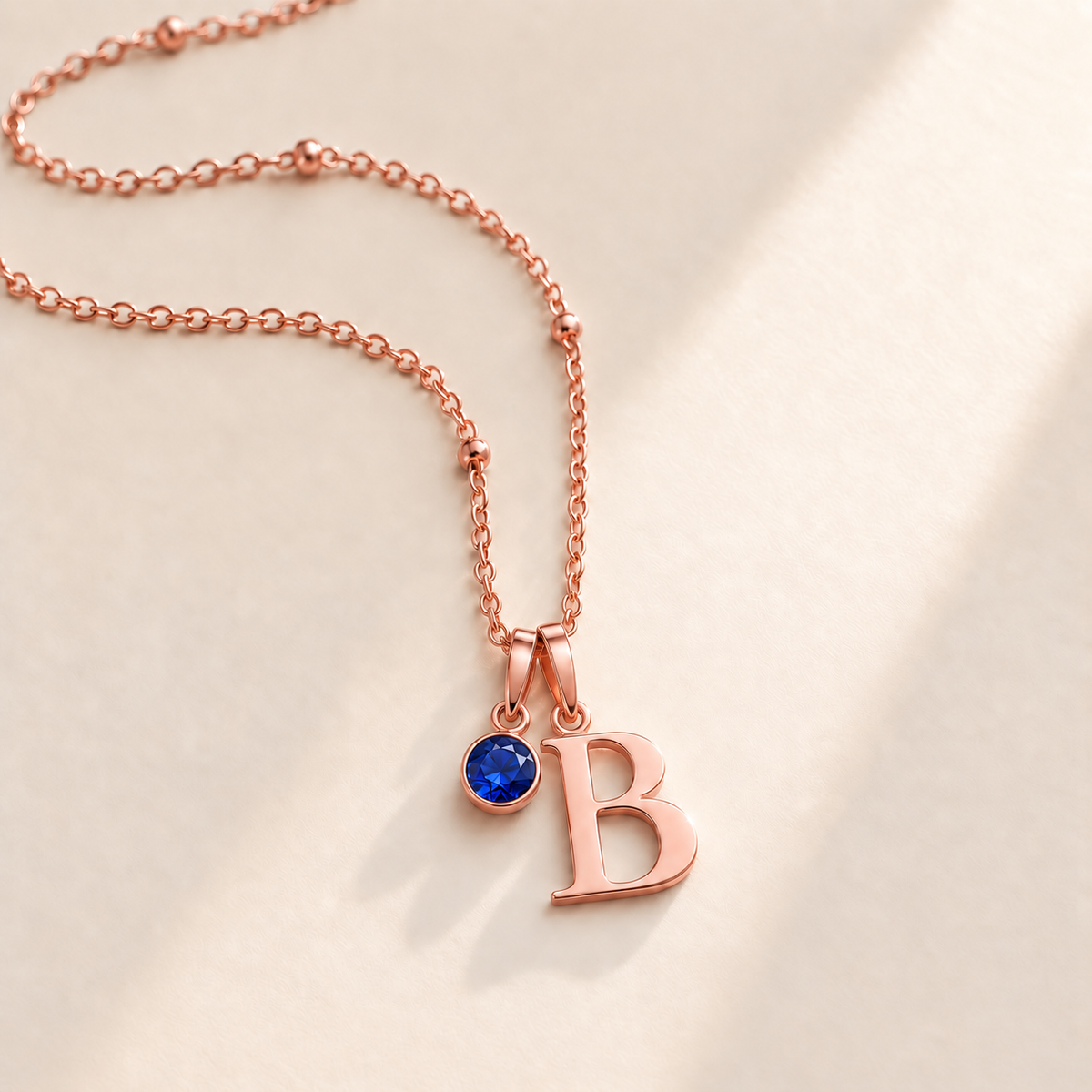 Custom Birthstone Initial Necklace september rose gold birthstone photo - serif initial B with round royal blue stone Anthology Jewelry
