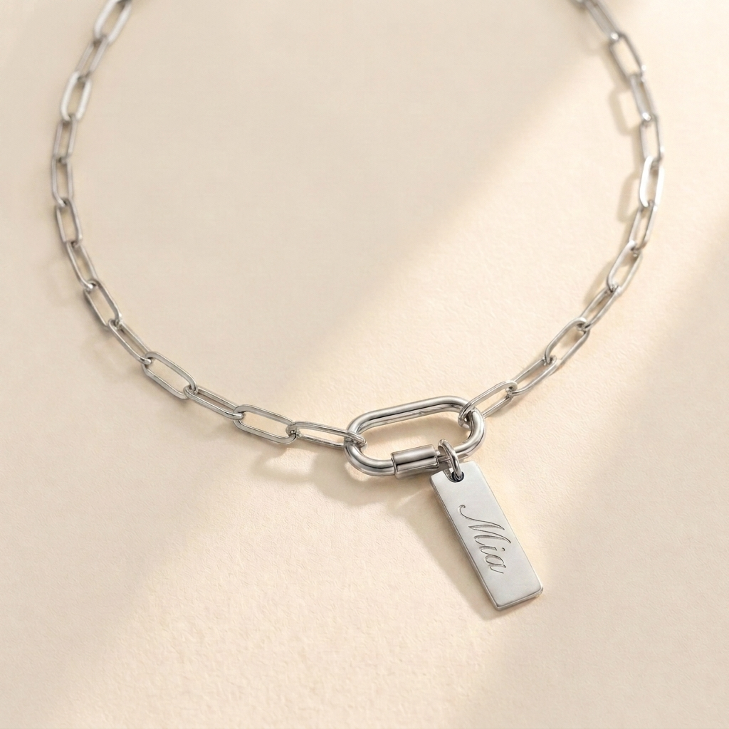 Custom Carabiner Charm Necklace hero photo - silver paperclip chain necklace with carabiner clasp and engraved charm on cream background Anthology Jewelry