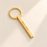 Custom Classic Column Keychain hero photo - gold engraved column on pale ivory with soft top-right light Anthology Jewelry