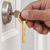 Older man using keys with a gold custom classic column keychain