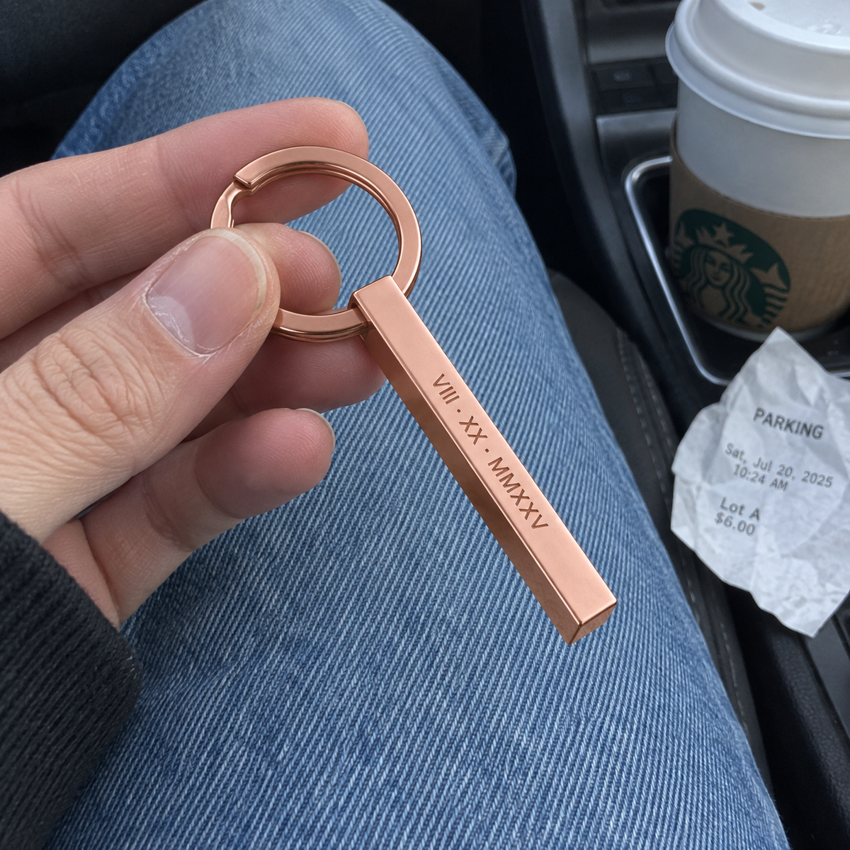 Casual phone photo of rose gold Roman numeral column keychain