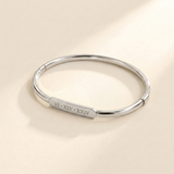 Custom Classic Hinge Bangle hero photo - silver Roman numeral bangle Anthology Jewelry