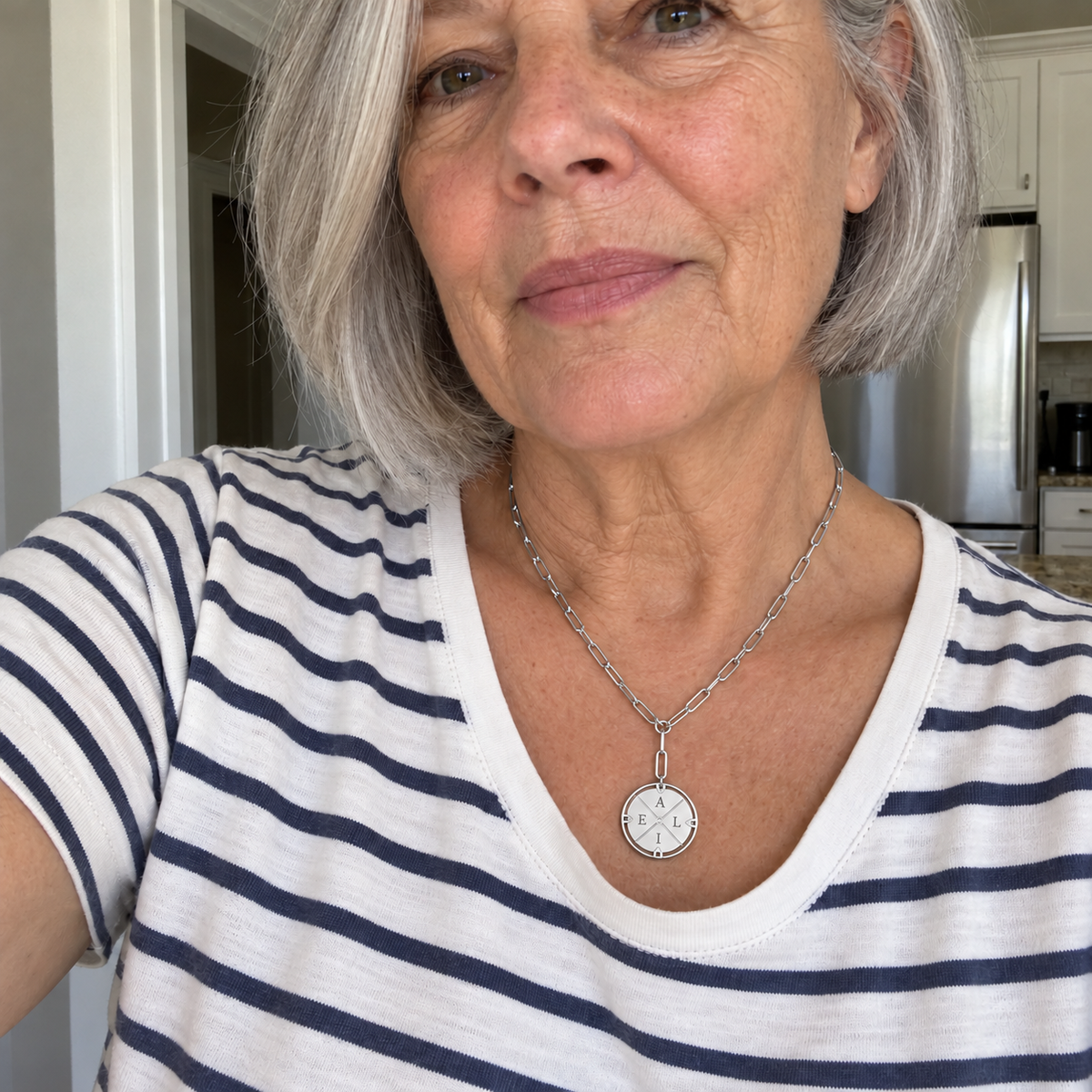 Custom Compass Initial Necklace UGC-style photo - silver finish with A top / L right / I bottom / E left personalization Anthology Jewelry