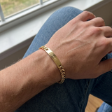 Custom Curb Chain ID Bracelet UGC photo - candid wrist shot wearing engraved gold curb chain ID bracelet Anthology Jewelry