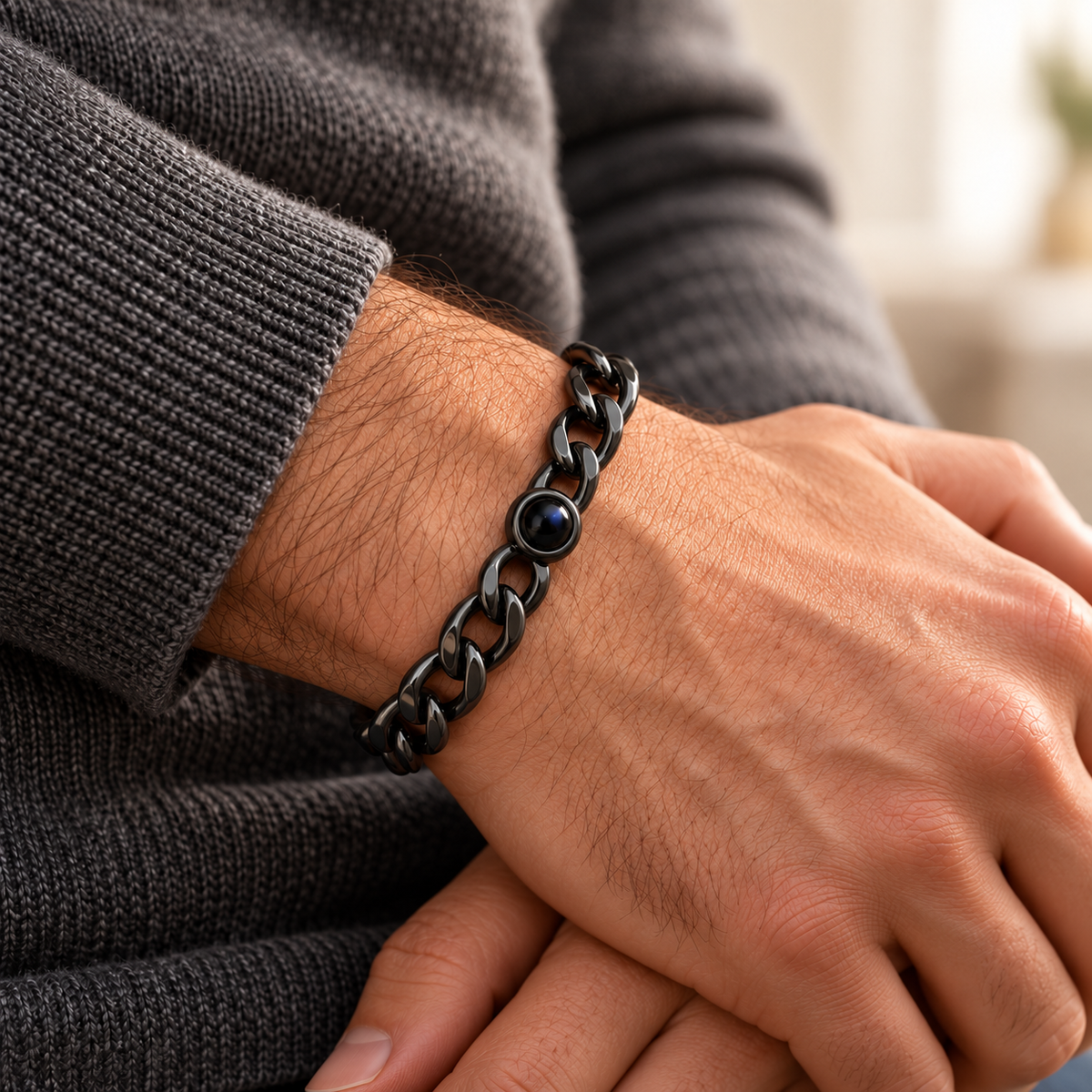 Custom Curb Link Photo Bracelet lifestyle photo - Black photo bracelet worn with charcoal knitwear, with open oval curb links and dark projection lens - Anthology Jewelry