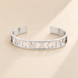 Custom Cut Out Cuff hero photo - silver MCMXCIV openwork cuff Anthology Jewelry