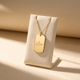 Custom Dog Tag Necklace displayed on jewelry stand with handwritten name engraving - Anthology Jewelry