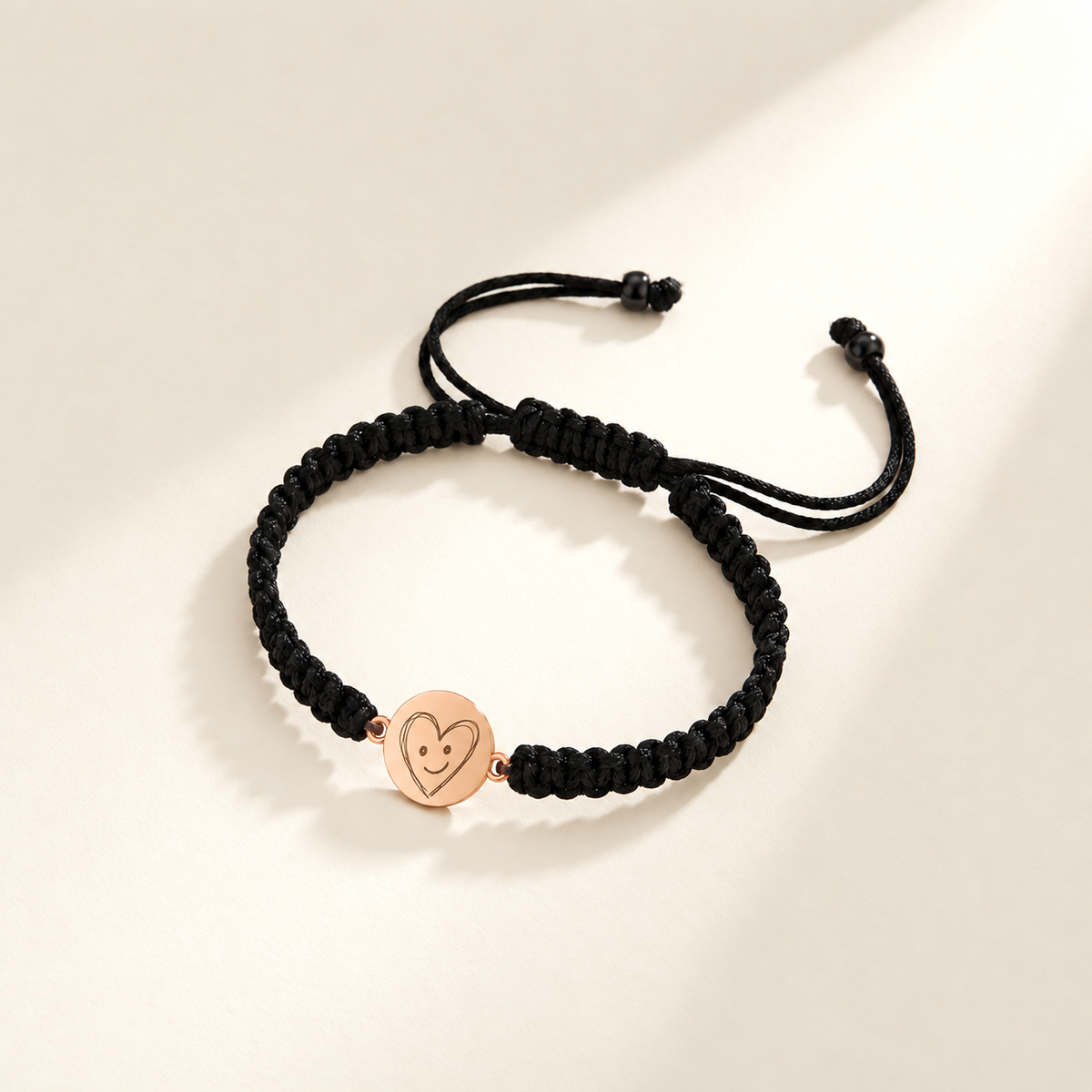 Custom Drawing Bracelet | Men's Black Braided Cord hero-rose-gold photo - rose gold irregular hand-drawn smiling heart engraving, generated design concept Anthology Jewelry