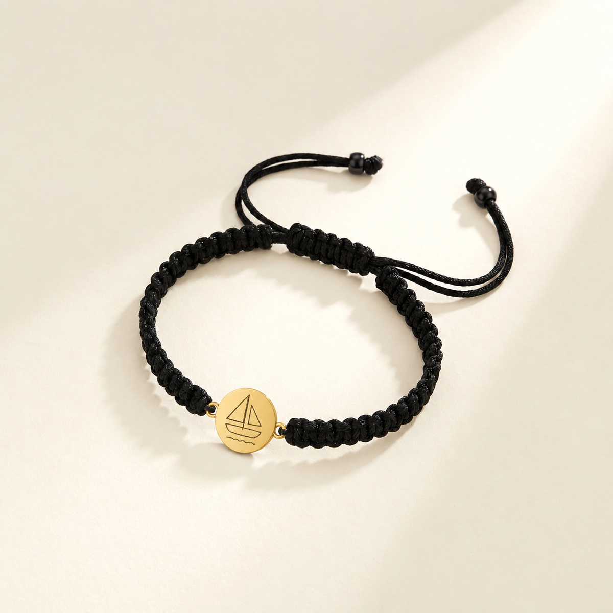 Custom Drawing Bracelet | Men's Black Braided Cord hero photo - original childlike sailboat engraved round disc on black braid Anthology Jewelry