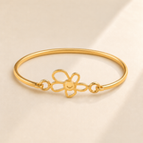 Custom Drawing Cuff Bracelet hero photo - gold five-petal open flower with connected solid gold center and smile detail, Anthology Jewelry