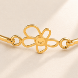 Custom Drawing Cuff Bracelet macro detail photo - gold five-petal open flower with connected solid gold center and smile detail, Anthology Jewelry