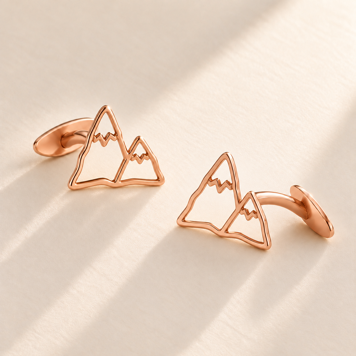 Custom Drawing Cufflinks hero photo - rose gold open hand-drawn mountain outline matching pair with fixed rear plates, generated design concept Anthology Jewelry