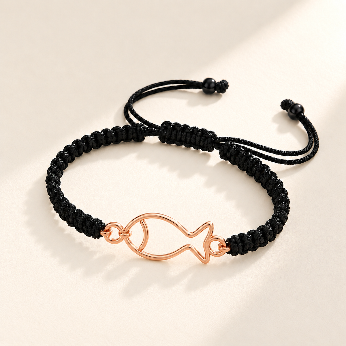 Custom Drawing Cutout Bracelet | Men's Black Braided Cord hero photo - rose gold open hand-drawn fish, generated design concept Anthology Jewelry