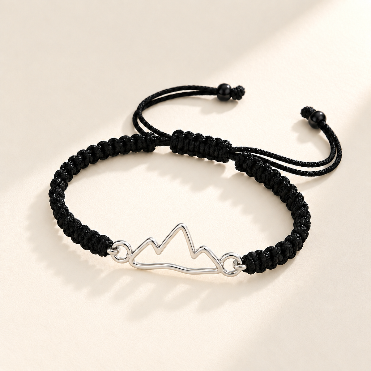 Custom Drawing Cutout Bracelet | Men's Black Braided Cord hero photo - silver open hand-drawn mountain outline, generated design concept Anthology Jewelry