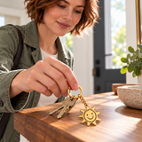 Custom Drawing Keychain professional-lifestyle photo - gold hand-drawn smiling sun, generated design concept Anthology Jewelry