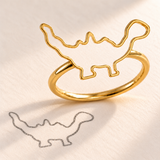 Custom Drawing Ring gold close-up - open dinosaur outline on a separate slim band beside the matching pencil drawing, generated design concept Anthology Jewelry