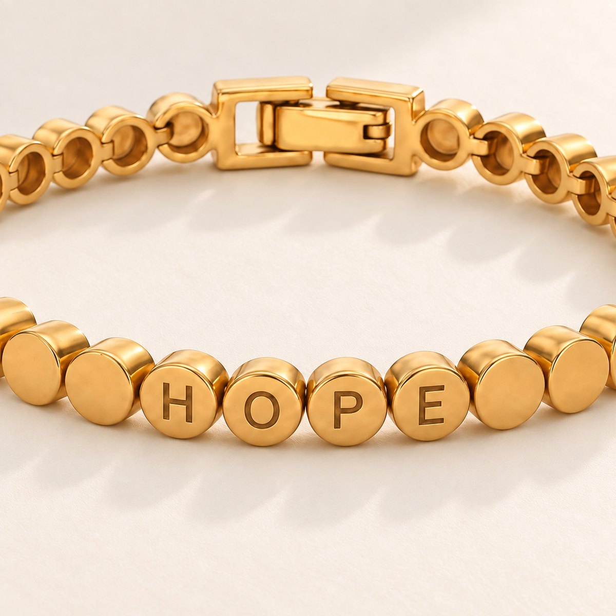 Custom Engraved Dot Bracelet detail photo - macro of engraved letters on linked round gold beads Anthology Jewelry