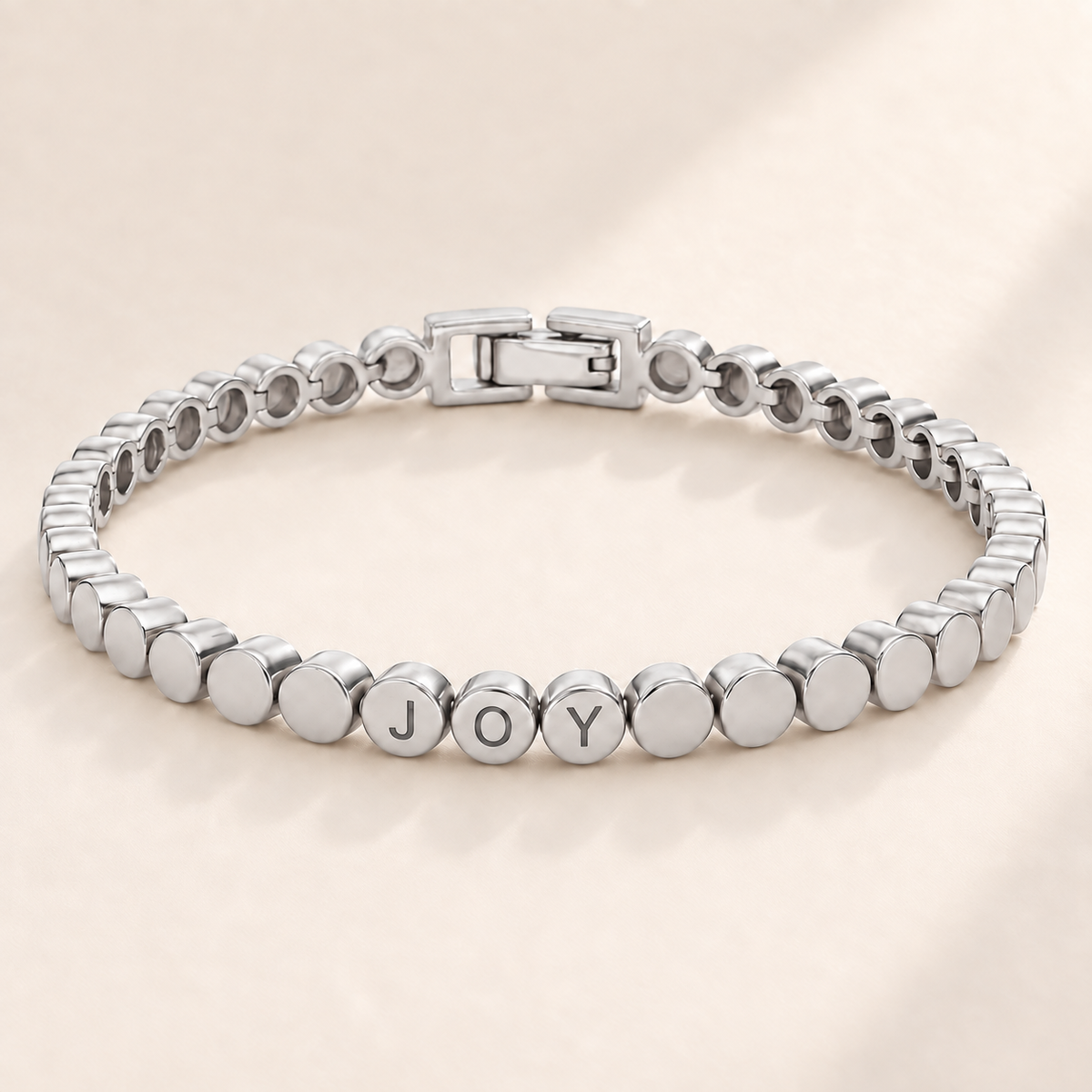 Custom Engraved Dot Bracelet hero photo - silver linked round beads with engraved letters Anthology Jewelry