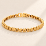 Custom Engraved Dot Bracelet hero photo - HOPE across four linked round gold beads Anthology Jewelry