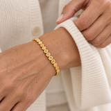 Custom Engraved Dot Bracelet lifestyle photo - gold linked dot bracelet with engraved letters worn on the wrist Anthology Jewelry