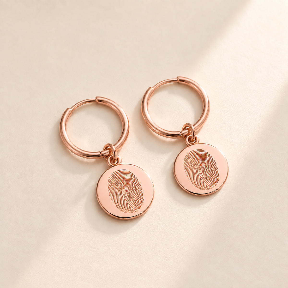 Custom Fingerprint Huggie Hoop Earrings hero photo - rose gold fingerprint disc huggie earrings Anthology Jewelry