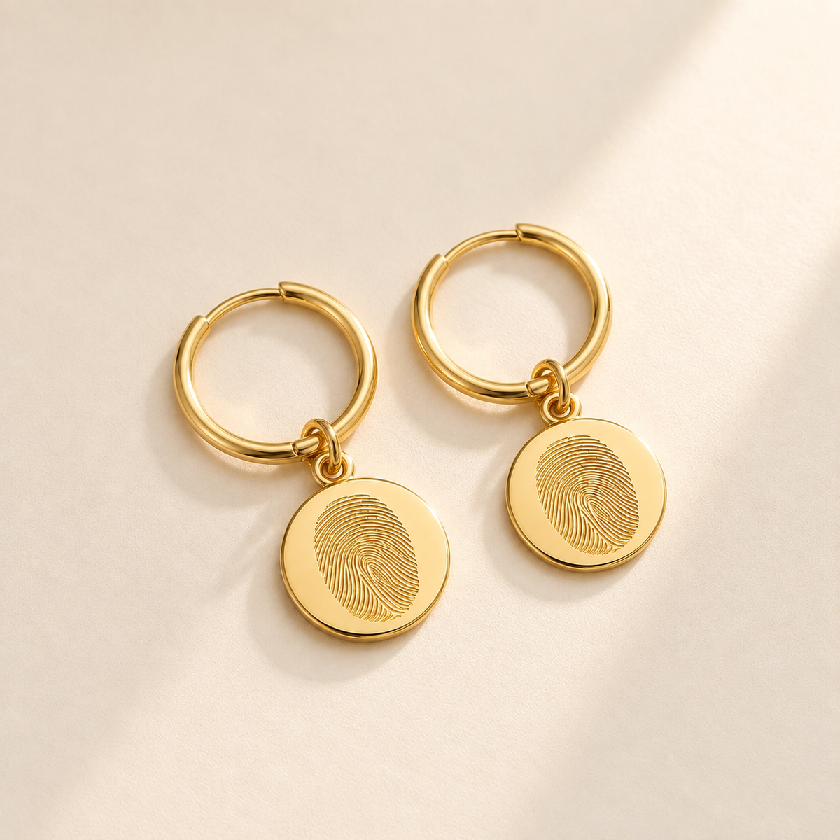 Custom Fingerprint Huggie Hoop Earrings hero photo - gold fingerprint disc huggie earrings Anthology Jewelry