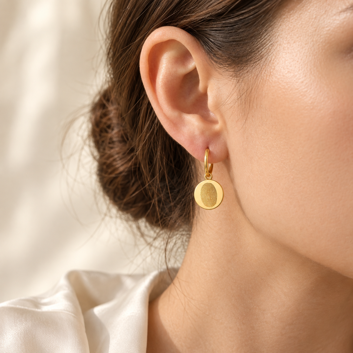 Custom Fingerprint Huggie Hoop Earrings lifestyle photo - woman wearing gold fingerprint huggie earring Anthology Jewelry