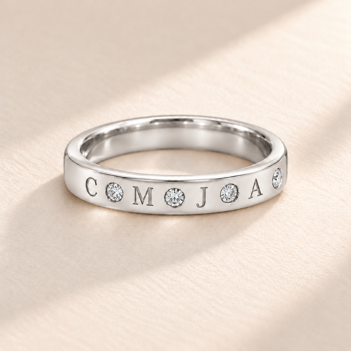 Silver flush stone initial band with four engraved initials C M J A