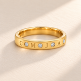 Gold flush stone initial band with four engraved initials C M J A