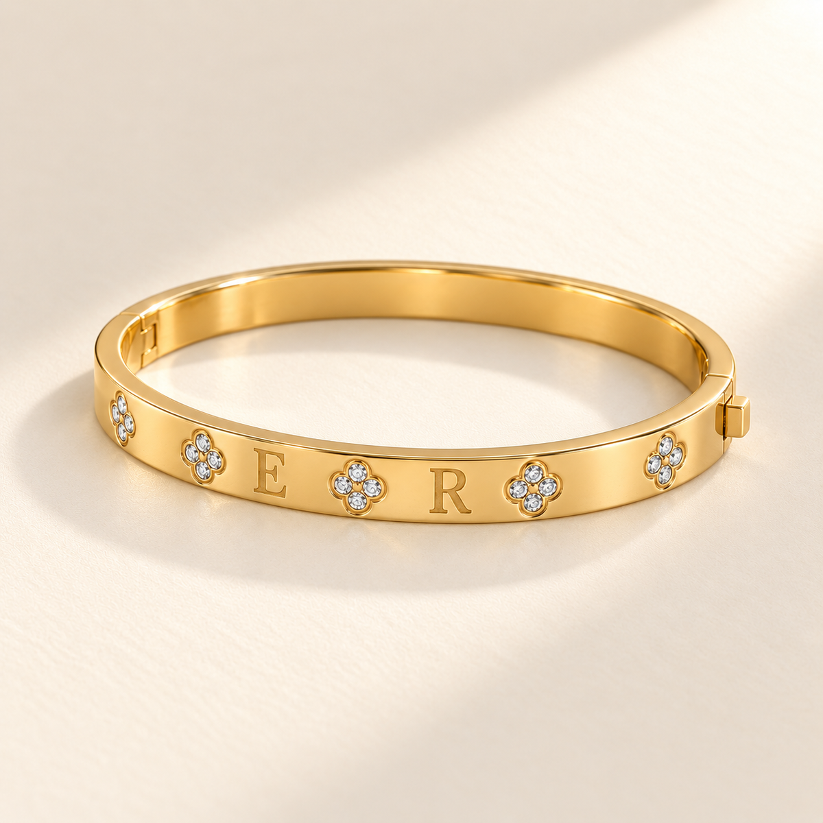 Custom Four-Stone Initial Bangle gold glamour product photo - rigid hinged bangle with E and R initials and fixed clear-stone motifs Anthology Jewelry