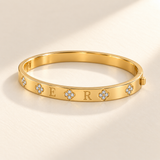 Custom Four-Stone Initial Bangle gold glamour product photo - rigid hinged bangle with E and R initials and fixed clear-stone motifs Anthology Jewelry