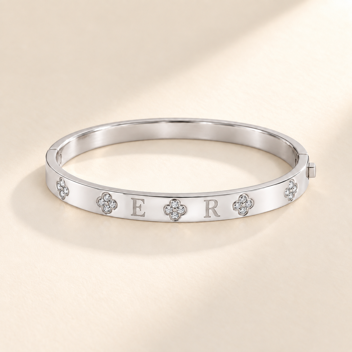 Custom Four-Stone Initial Bangle silver hero photo - rigid hinged bangle with E and R initials and fixed clear-stone motifs Anthology Jewelry
