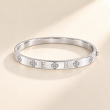 Custom Four-Stone Initial Bangle silver hero photo - rigid hinged bangle with E and R initials and fixed clear-stone motifs Anthology Jewelry
