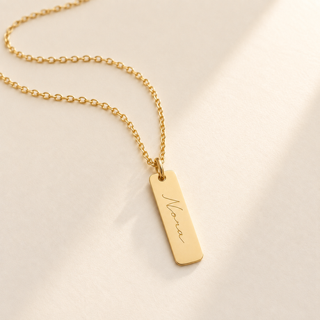 Custom Handwriting ID Necklace hero photo - gold handwriting ID pendant on ivory Anthology Jewelry