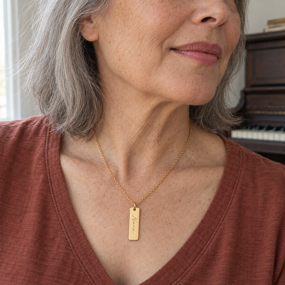 Custom Handwriting ID Necklace professional close model photo - gold ID pendant worn on an older woman Anthology Jewelry