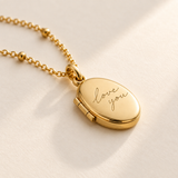 Close studio view of gold handwriting mini locket