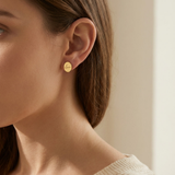 Custom Handwriting Oval Stud Earrings lifestyle photo - gold handwritten oval stud worn on the ear Anthology Jewelry
