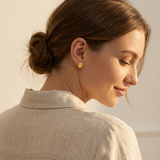 Custom Handwriting Oval Stud Earrings lifestyle photo - woman with low bun wearing gold handwritten oval studs Anthology Jewelry