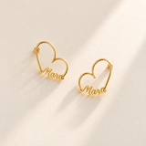 Custom Heart-Frame Name Stud Earrings gold hero on pale ivory background - Anthology Jewelry