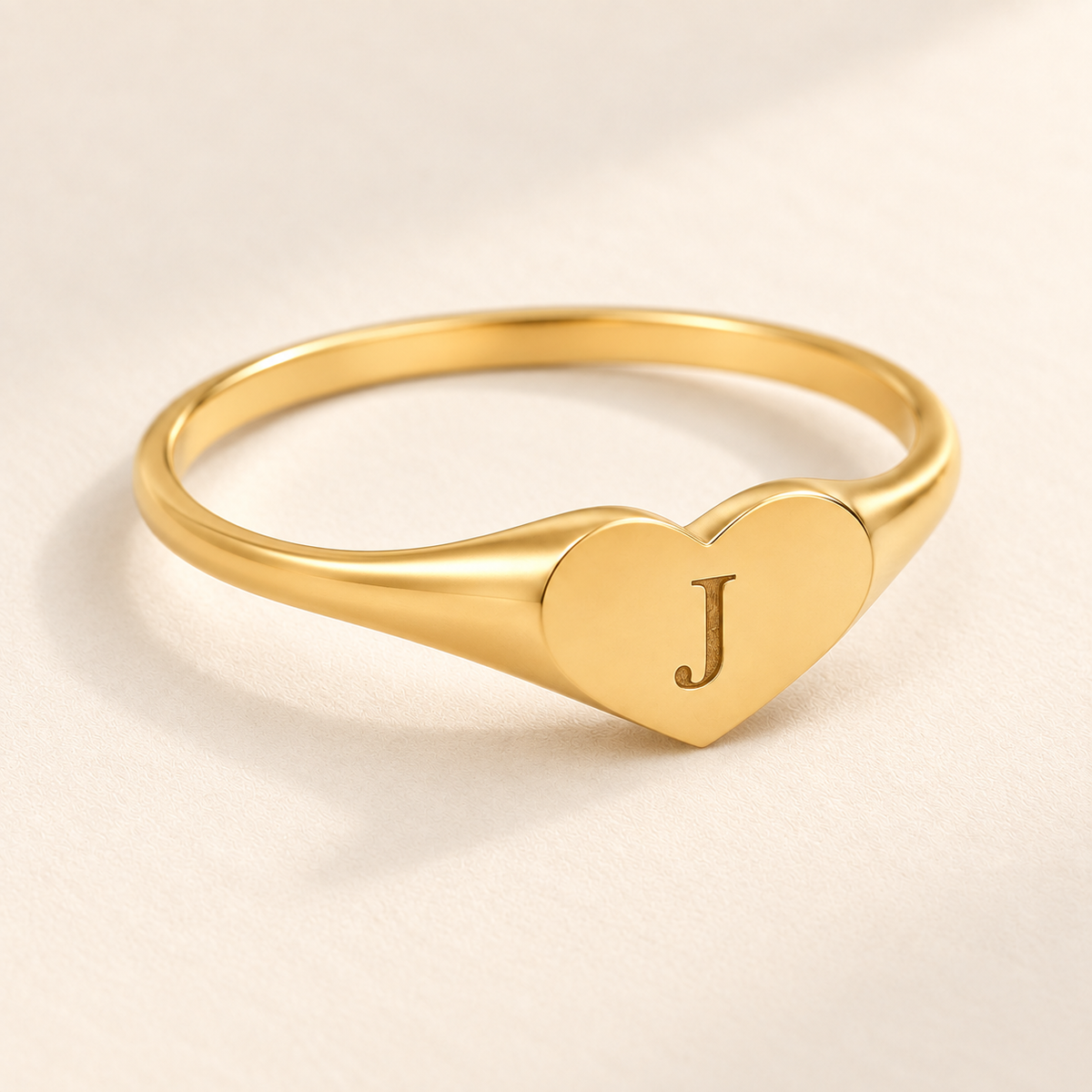 Custom Heart Signet Initial Ring detail photo - macro of the heart-shaped signet face with an engraved initial Anthology Jewelry